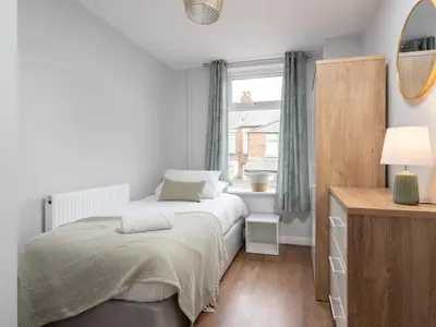 a bedroom with a bed and a window at Ivy House, 3 Bed House, Parking - Pass the Keys in Liverpool