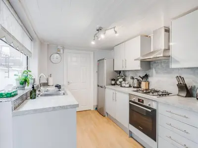 a kitchen with white cabinets and a sink at Ivy House, 3 Bed House, Parking - Pass the Keys in Liverpool