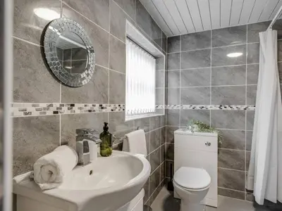a bathroom with a sink and a toilet and a mirror at Ivy House, 3 Bed House, Parking - Pass the Keys in Liverpool