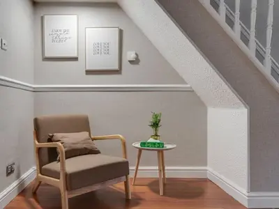 a living room with a chair and a table at Ivy House, 3 Bed House, Parking - Pass the Keys in Liverpool