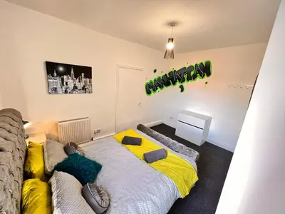 a bedroom with a bed and a sign that reads birthday at Manhattan loft Apartment by Wilom in Blackpool