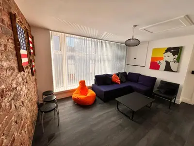 a living room with a blue couch and a table at Manhattan loft Apartment by Wilom in Blackpool