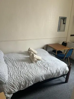 a bedroom with a bed with a stuffed animal on it at Apollo Number 7 in Blackpool