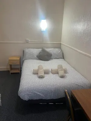a bedroom with a bed with two pillows on it at Apollo Number 7 in Blackpool