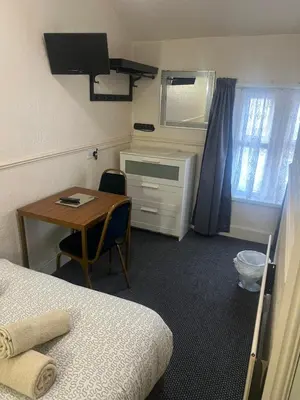 a room with a desk and a table and a bed at Apollo Number 7 in Blackpool