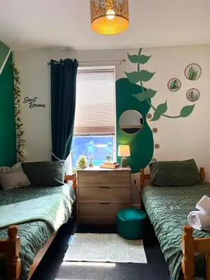 a bedroom with two twin beds and a window at Winter Gardens Flat 2 - Studio The Retreat in Blackpool
