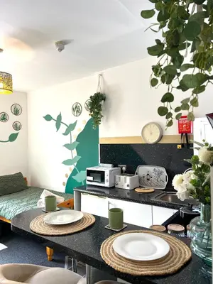 a living room with two plates on a table at Winter Gardens Flat 2 - Studio The Retreat in Blackpool