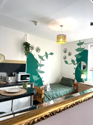 a living room with a bed and a kitchen at Winter Gardens Flat 2 - Studio The Retreat in Blackpool