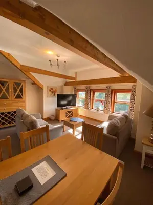 a living room with a couch and a table at Garnett - Comfy apartment, great location! in Clitheroe