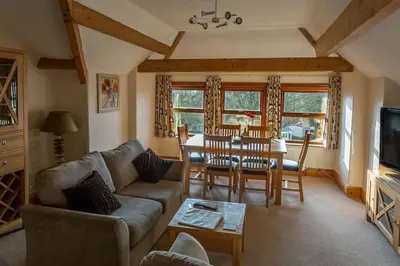 a living room with a couch and a table at Garnett - Comfy apartment, great location! in Clitheroe
