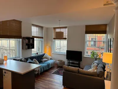 a living room with two couches and a table at City Centre Apartment Liverpool in Liverpool