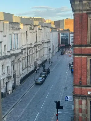 a city street with cars parked on the street at City Centre Apartment Liverpool in Liverpool
