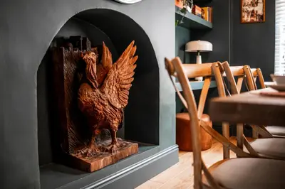 a wooden statue of a chicken in a fireplace at Arkles - Victorian Gem in Liverpool