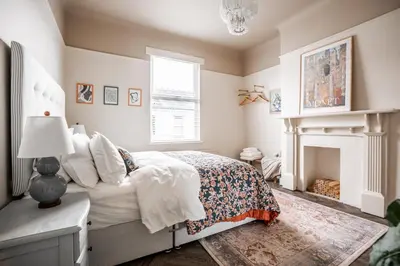 a bedroom with a bed and a fireplace at Arkles - Victorian Gem in Liverpool