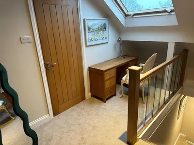 an attic room with a desk and a skylight at Lovely country cottage in Dalton / Parbold in Wigan