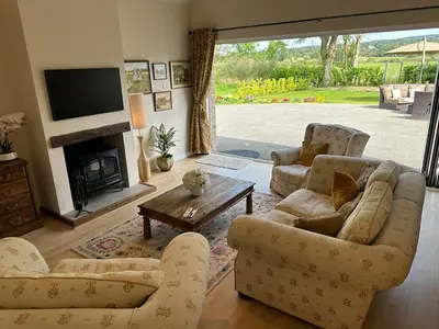 a living room with two couches and a tv at Lovely country cottage in Dalton / Parbold in Wigan