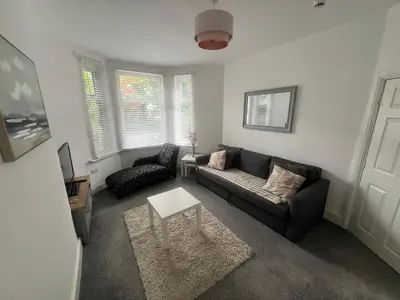 a living room with a couch and a table at New Flat in Lytham St Annes - Sleeps 4 in Saint Annes on the Sea