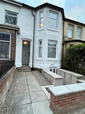 a white house with a front door and a sidewalk at New Flat in Lytham St Annes - Sleeps 4 in Saint Annes on the Sea