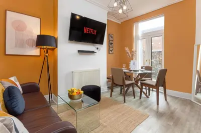a living room with a couch and a table at Edge Grove Retreat - Air Host & Stay in Liverpool