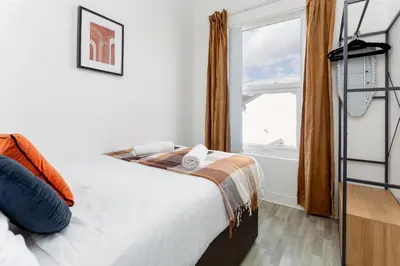 a bedroom with a bed and a window at Edge Grove Retreat - Air Host & Stay in Liverpool