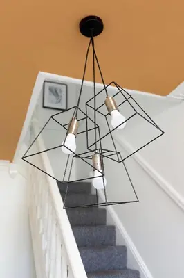 a glass pendant light hanging over a staircase at Edge Grove Retreat - Air Host & Stay in Liverpool