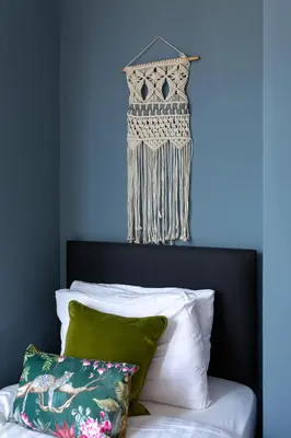 a bedroom with a blue wall and a bed with pillows at Edge Grove Retreat - Air Host & Stay in Liverpool