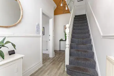 a staircase in a home with a mirror at Edge Grove Retreat - Air Host & Stay in Liverpool