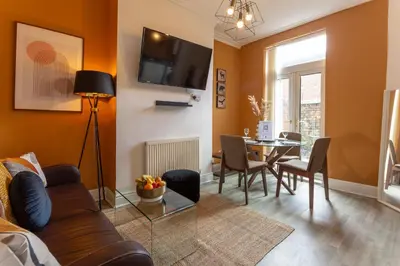 a living room with a couch and a table at Edge Grove Retreat - Air Host & Stay in Liverpool