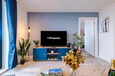 a living room with a tv on a blue cabinet at NEW! Pristine 2-Bed Flat on Liverpool by 53 Degrees Property, Amazing Location, Sleeps 6! in Liverpool