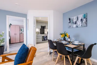 a dining room and living room with a table and chairs at NEW! Pristine 2-Bed Flat on Liverpool by 53 Degrees Property, Amazing Location, Sleeps 6! in Liverpool