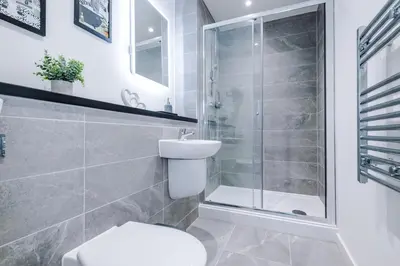 a bathroom with a shower and a toilet and a sink at NEW! Pristine 2-Bed Flat on Liverpool by 53 Degrees Property, Amazing Location, Sleeps 6! in Liverpool