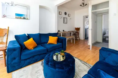 a living room with a blue couch and a table at Liverpool City Haven-Dane Street in Liverpool