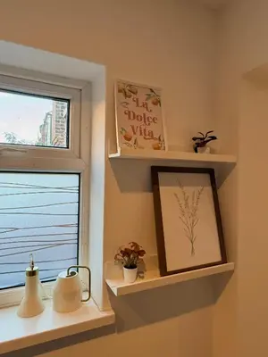 a room with shelves and a window with a picture at Cityscape-Cosy House By Anfield in Liverpool