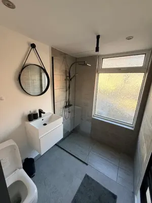 a bathroom with a shower and a sink and a toilet at Cityscape-Cosy House By Anfield in Liverpool