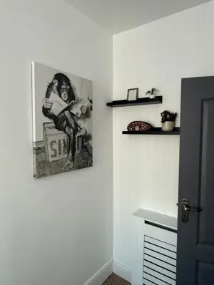 a picture of a man playing a guitar on a wall at Cityscape-Cosy House By Anfield in Liverpool