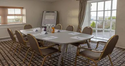 a meeting room with a table and chairs at Best Western Plus Lancashire Manor Hotel in Skelmersdale