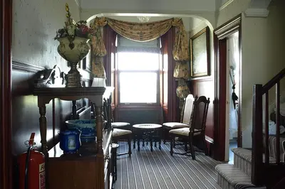 a living room with a table and chairs and a window at Duddon Villa in Millom