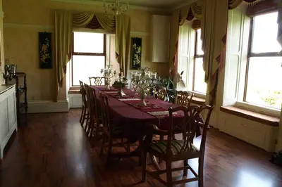 a dining room with a long table and chairs at Duddon Villa in Millom