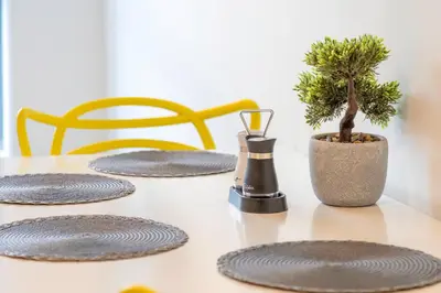 a table with four chairs and a plant on it at L1 Comfy Escapes - Long Stay Discounts Apply! in Liverpool