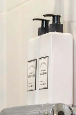 two bottles of soap sitting on top of a counter at L1 Comfy Escapes - Long Stay Discounts Apply! in Liverpool