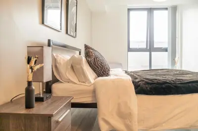 a bedroom with a large bed and a window at L1 Comfy Escapes - Long Stay Discounts Apply! in Liverpool