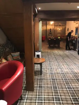 a living room with a red couch and a table at 26 Sherwood, South Lakeland Leisure Village in Carnforth