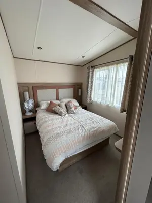 a bedroom with a bed and a window at Deck Of The Bay in Heysham
