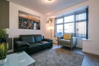 a living room with a couch and a chair at Modern Home: Heart Of Blackburn in Blackburn