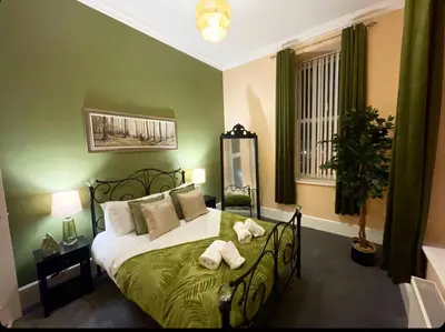 a bedroom with a bed with two towels on it at Apartment 2 West County by Prestige Properties SA in Millom