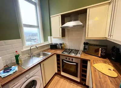a kitchen with a sink and a washing machine at Apartment 2 West County by Prestige Properties SA in Millom