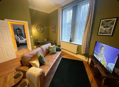 a living room with a couch and a flat screen tv at Apartment 2 West County by Prestige Properties SA in Millom