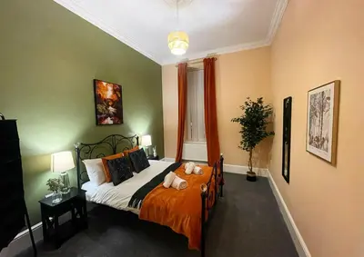 a bedroom with a bed with two stuffed animals on it at Apartment 2 West County by Prestige Properties SA in Millom