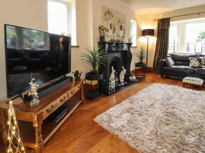 a living room with a large flat screen tv at Linwood in Thornton