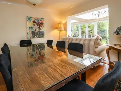 a living room with a wooden table and chairs at Linwood in Thornton